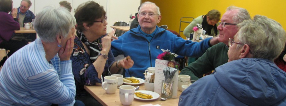People with dementia and their carers at a meeting.
