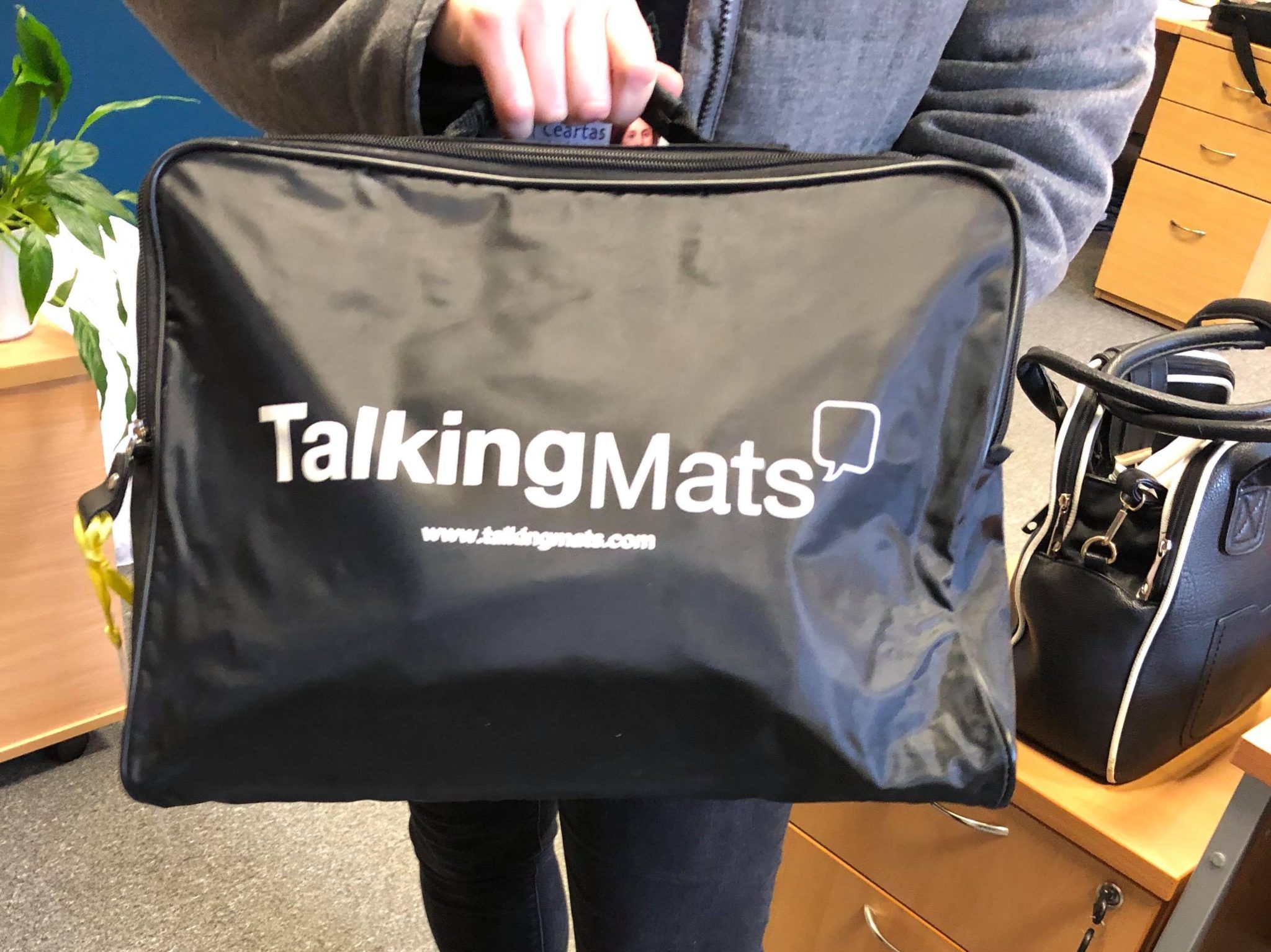 Advocacy worker holding Talking Mats bag